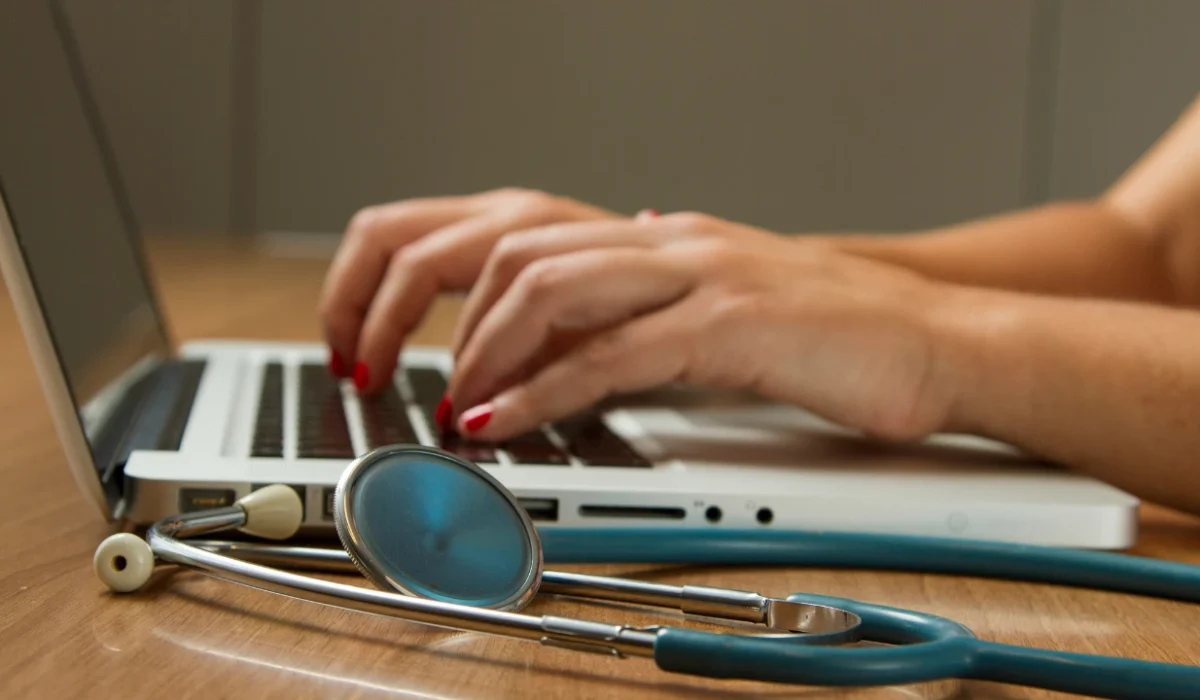 Chiropractic biller working on insurance claims at a laptop